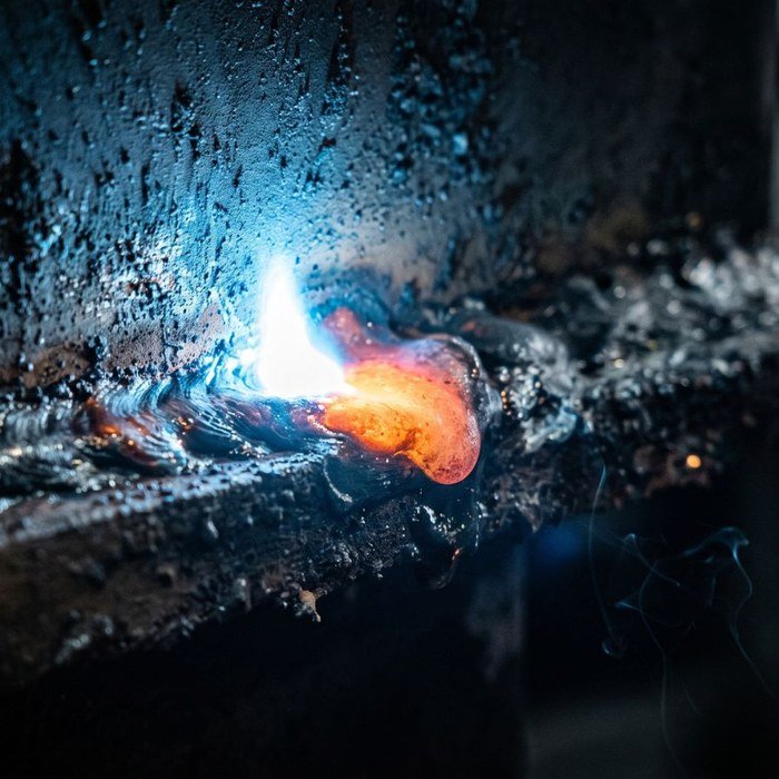 Welder working on a fabricated beam
